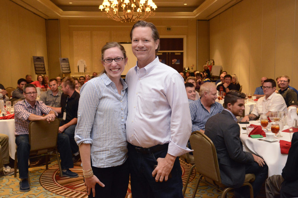Tamela Triplett, left, poses with Brad Smith, right, after receiving the second-annual Bill Eppridge Memorial Award.